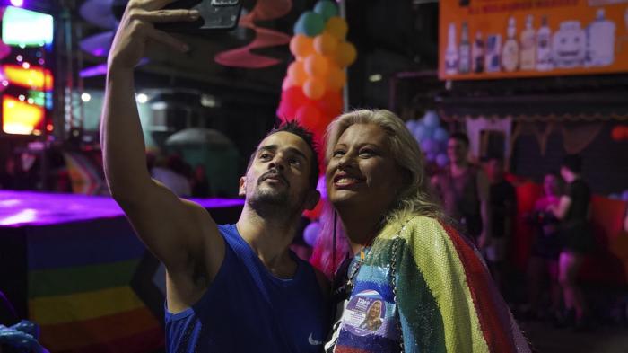 Indianarae Siqueira, a transgender woman running for city council, poses for a selfie with a supporter at an LGBTQIA+ pride parade in the Mare neighborhood of Rio de Janeiro, Sunday, Sept. 29, 2024. 