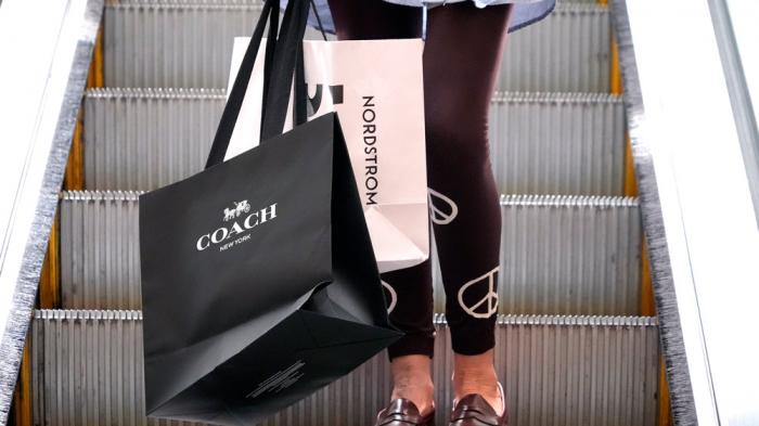 A shopper carries bags in Pittsburgh on June 3, 2024. (AP Photo/Gene J. Puskar, File)