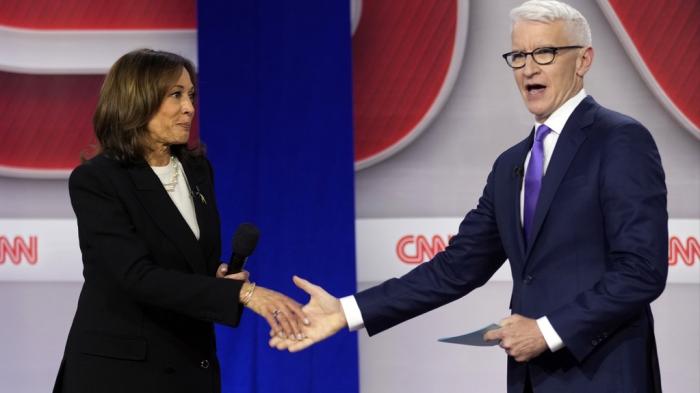 Democratic presidential nominee Vice President Kamala Harris shakes hands with moderator Anderson Cooper at a CNN town hall in Aston, Pa., Wednesday, Oct. 23, 2024. 