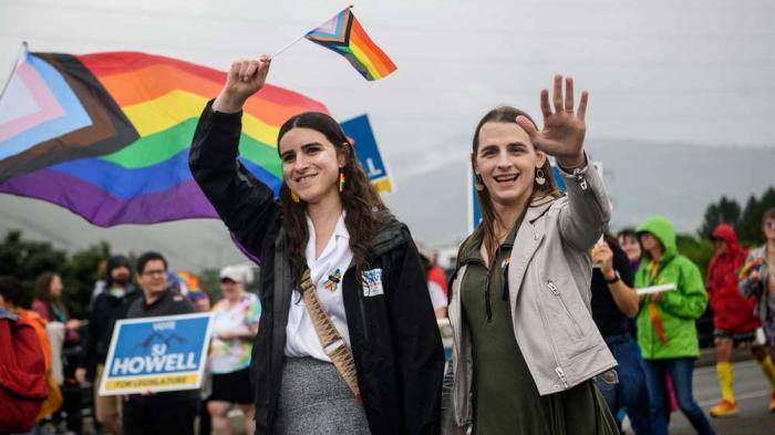 Missoula Rep. Zooey Zephyr, right, and her fiancee Erin Reed, left, wave to supporters during the Missoula Pride Parade, June 17, 2023, in Missoula, Mont.