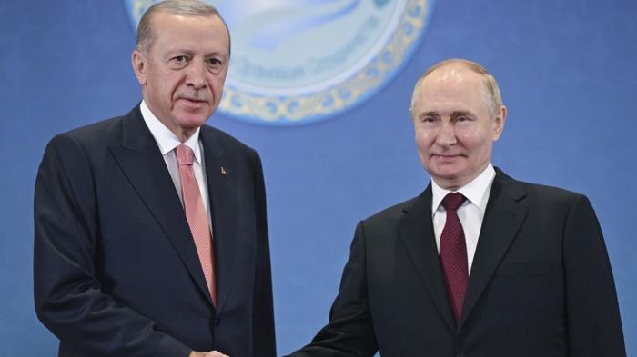 Russian President Vladimir Putin, right, and Turkish President Recep Tayyip Erdogan shake hands as they pose for photos during a meeting on the sidelines of the Shanghai Cooperation Organization summit in Astana, Kazakhstan, on July 3, 2024.