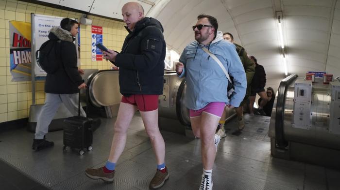 People take part in the annual event "No Trousers Tube Ride" in London, Sunday, Jan. 12, 2025.