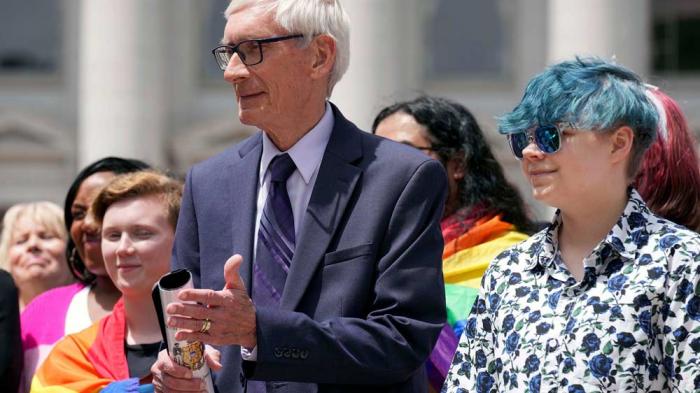 Wisconsin Gov. Tony Evers, left, attends a Rainbow Pride flag raising, June 1, 2022 at the Capitol in Madison, Wis.