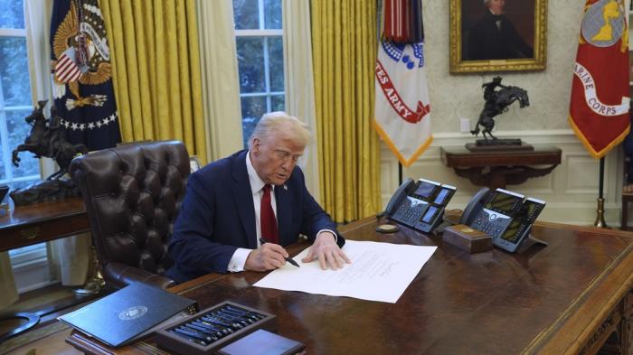 President Donald Trump signs executive orders in the Oval Office at the White House, Thursday, Jan. 30, 2025, in Washington.