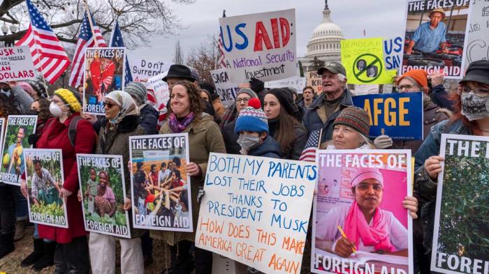 Demonstrators and lawmakers rally against President Donald Trump and his ally Elon Musk as they disrupt the federal government, including dismantling the U.S. Agency for International Development, which administers foreign aid approved by Congress, on Capitol Hill in Washington, Wednesday, Feb. 5, 2025