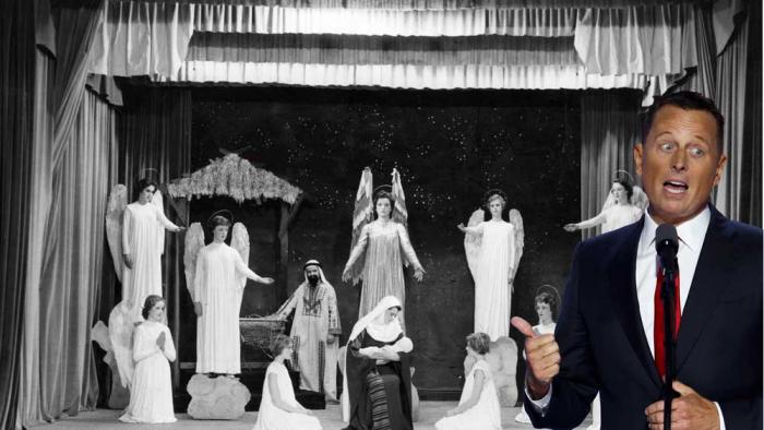 Ric Grenell (left) before a photo of a religious play celebrating the life of Jesus Christ.