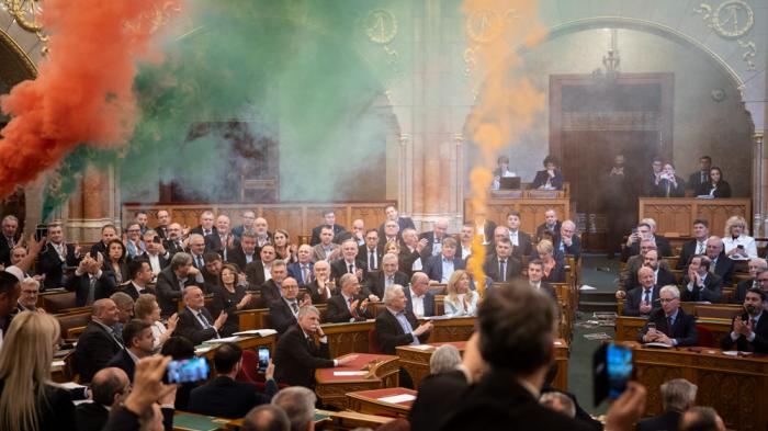 MPs of Momentum protest with flares during the plenary session of the Hungarian parliament in Budapest, Hungary, Tuesday, March 18, 2025