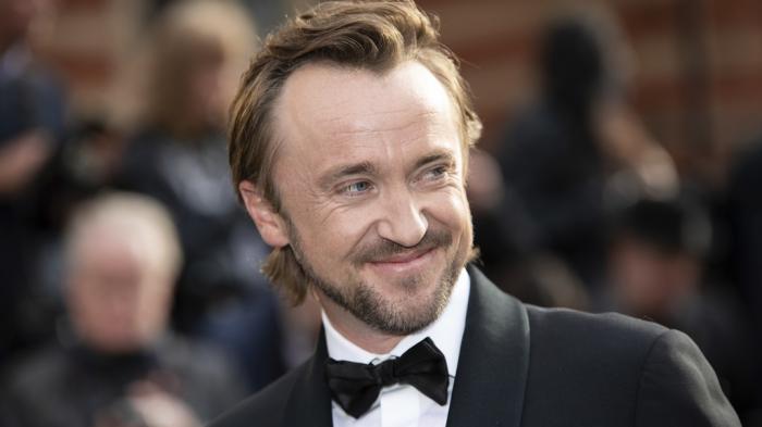 Tom Felton poses for photographers upon arrival at the Olivier Awards in London, Sunday, April 10, 2022. 