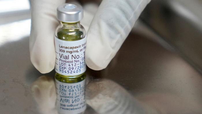 A pharmacist holds a vial of lenacapavir, an injectable HIV prevention drug, at the Desmond Tutu Health Foundation's Masiphumelele Research Site, in Cape Town, South Africa, Tuesday, July 23, 2024, which was one of the sites for Gilead's lenacapavir drug trial. (AP Photo/Nardus Engelbrecht, File)