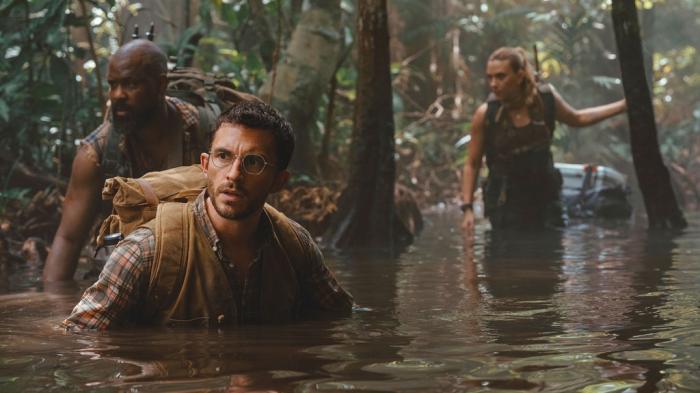 From left, Bechir Sylvain, Jonathan Bailey, and Scarlett Johansson in a scene from " Jurassic World Rebirth." 