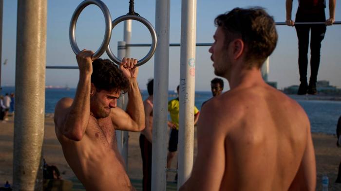 People work out in an open-air gym next to the beach in Barcelona, Spain, Tuesday, June 25, 2025