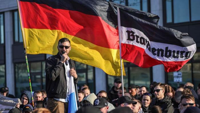 Extremist Ferhat Sentürk, a former politician of the far-right Alternative for Germany (AfD) addresses far-right activists gathered near the Ostkreuz railway station before marching on March 22, 2025 in Berlin, Germany.