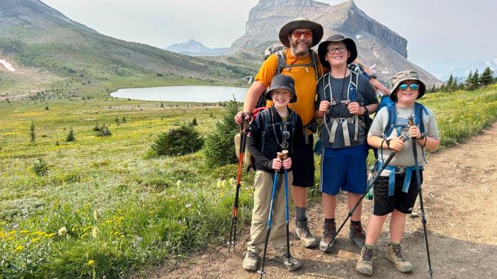 This undated photo shows the Campbell family, wearing sun protection shirts and hats, posing for a photo during a hike in the Rocky Mountains near their Calgary, Alberta home